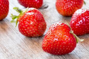 Close-up view of fresh strawberry on wooden floor