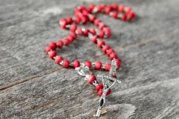 Close-up view of rosary on  wooden texture background