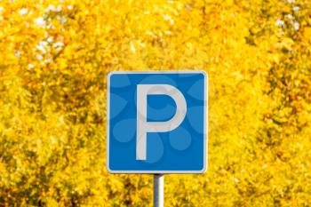 Parking sign on beautiful autumn trees background