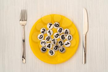 Fork, knife and plate with numbers. Hungry for knowledge, brain feeding concept