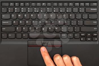Close-up of the hand are using laptop touchpad. Top view.