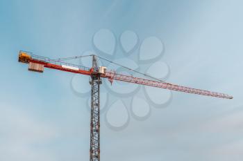 Tower crane with blue sky background. Construction site.