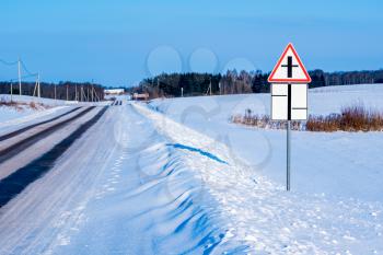 The sign on the road in field in snowy winter