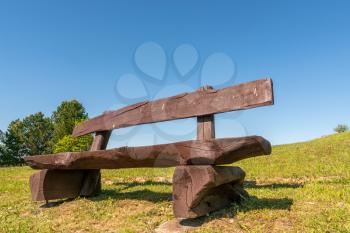 Empty wooden bench on blue sky background 