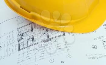 Construction plan with yellow helmet