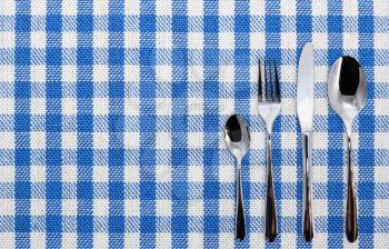 Lined white and blue dining cloth with silverware
