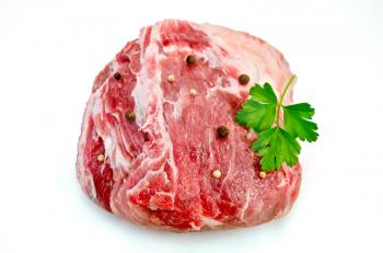 Large piece of meat with peas pepper and parsley isolated on white background