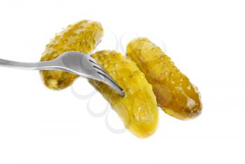 Royalty Free Photo of Three Pickles and a Fork