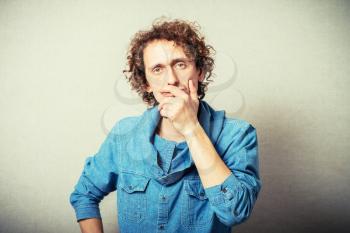 curly-haired man covers her mouth