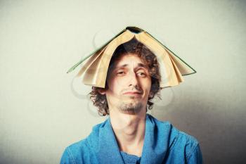 man with a book on his head