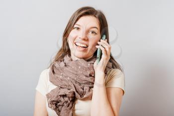 Young beautiful smiling woman talking on cell phone