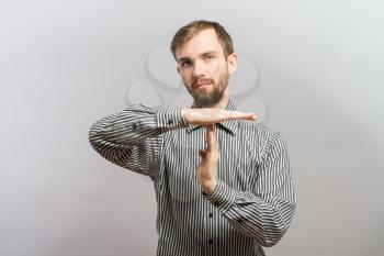 Portrait of young man gesturing time out sign