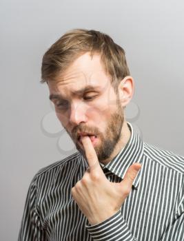 Closeup portrait young man with sensitive toothache bridge problem about to cry from oral pain touching outside mouth with hand. Negative emotion facial expression feeling