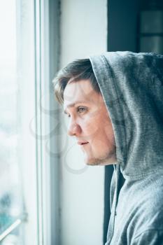 Traveling by train. Man traveling by train, looking through the dirty window.