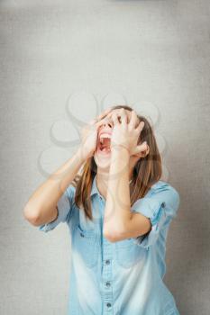 girl shouts, hands covering his face