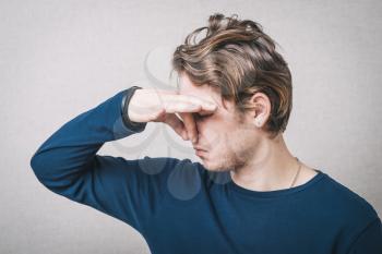 man closes his nose stinks