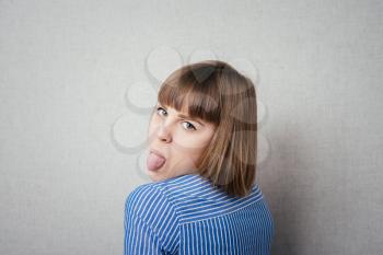 Girl sticking her tongue out, isolated