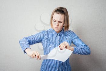 girl tearing the paper into small pieces