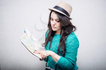Girl in a hat and travel maps