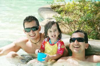 Happy family having fun in swimming pool.  Brothers and niece having fun in the pool on summer vacation 