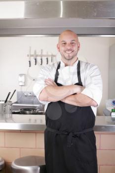 Portrait of young male chef in commercial kitchen