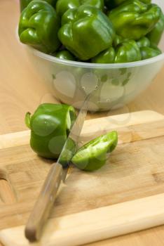 Royalty Free Photo of Green Peppers on a Cutting Board