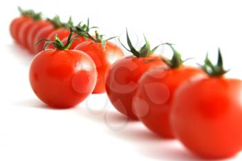 Royalty Free Photo of a Row of Tomatoes With One Set Out