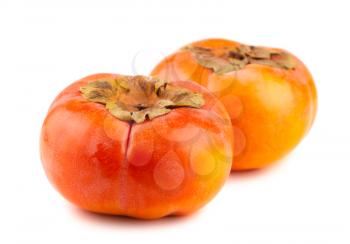 Two ripe persimmon fruits isolated on a white background