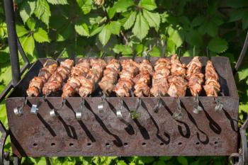 Shashlyk (kebab) grilling on the bbq, closeup view
