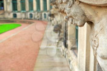 Closeup naked satyr smiling statue crop at Zwinger palace in Dresden, Germany

