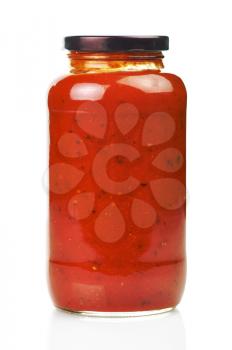 Glass jar of hot tomato sauce on a white background
