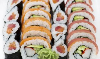Sushi rolls with salmon and tuna , close up on white background