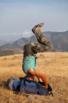 Royalty Free Photo of a Man doing a Headstand in the Mountains