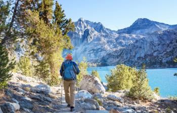 Man with hiking equipment walking in Sierra Nevada mountains, California, USA