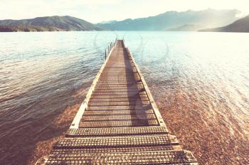 Wooden pier in serenity mountains lake