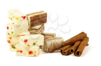 Sweets and cinnamon sticks isolated on white background