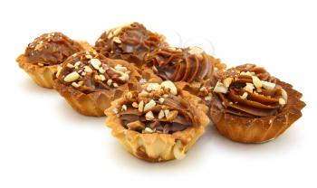 Pie a basket with chocolate condensed milk and nuts on a white background