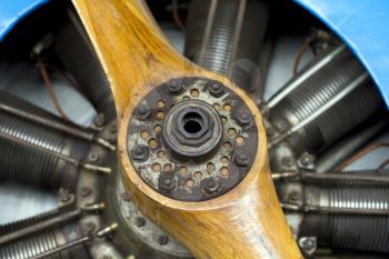 Old aircraft engine with wood propeller, vintage plane close up