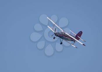 A beautiful white plane flies against a blue sky.