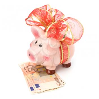 Christmas deposit concept. Piggy bank with festive bow isolated on white.