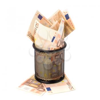 Waste of money concept. Euro currency in garbage bin isolated on white background.