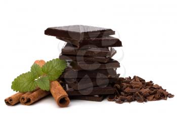 Chocolate bars stack and cinnamon sticks isolated on white background