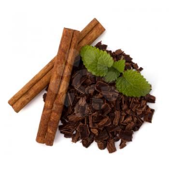 Crushed chocolate shavings pile and cinnamon sticks isolated on white background