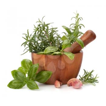 fresh flavoring herbs and spices in wooden mortar isolated on white background