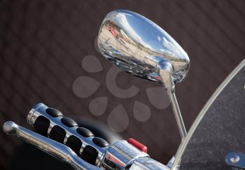 Chromed mirror on motobike as a detail