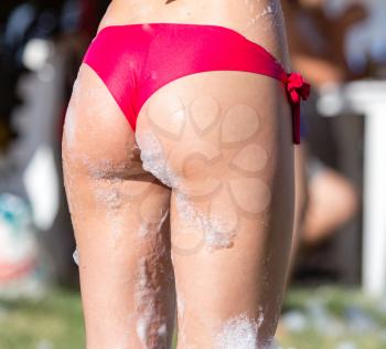 Ass girlfriend at a foamy party on the beach .