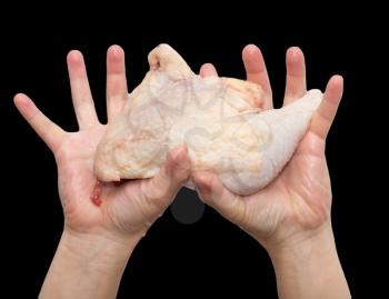 chicken leg in hand on a black background