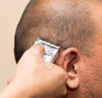 Man having a haircut with a hair clippers