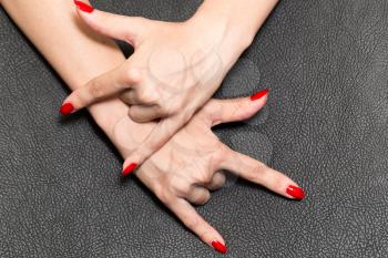 hand with red nail polish. rock