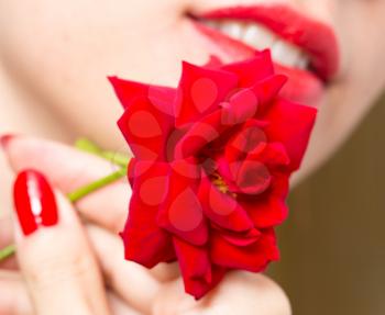 red rose, red manicure and red lips